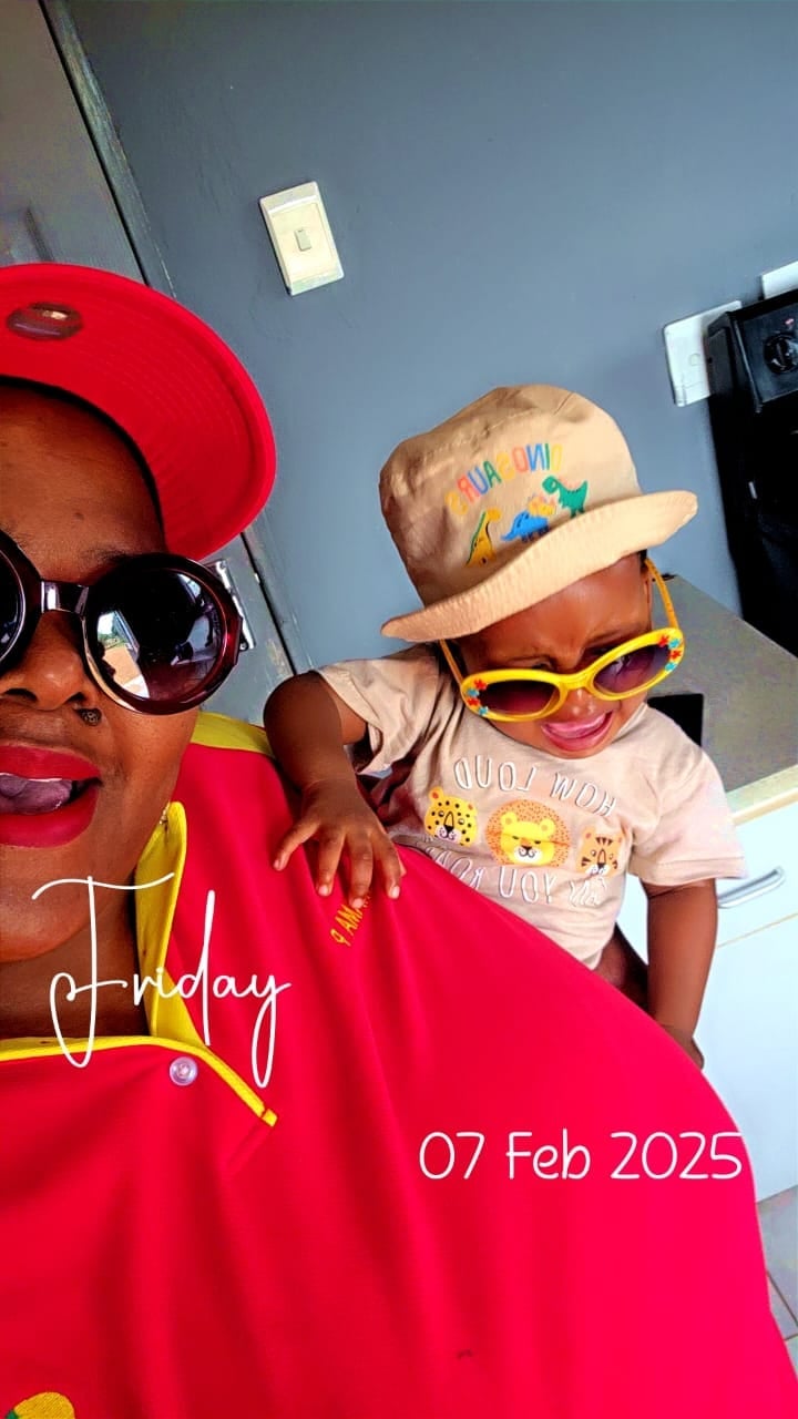 Adult and child wearing colorful sunglasses and hats at a birthday celebration on February 7, 2025